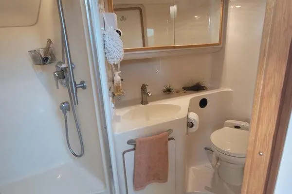 Slide: The Image of Bathroom interior of 1995 Sea Ray 440 Express Bridge yacht, featuring shower and sink. - 21