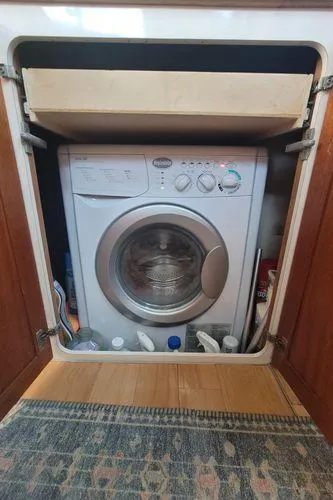 Slide: The Image of Washing machine inside a cabinet on a 1995 Sea Ray 440 Express Bridge boat. - 25