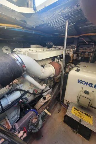 Slide: The Image of Engine room of 1995 Sea Ray 440 Express Bridge with Kohler generator and batteries. - 27