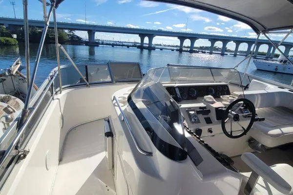 Slide: The Image of 1995 Sea Ray 440 Express Bridge yacht helm with scenic bridge view. - 6