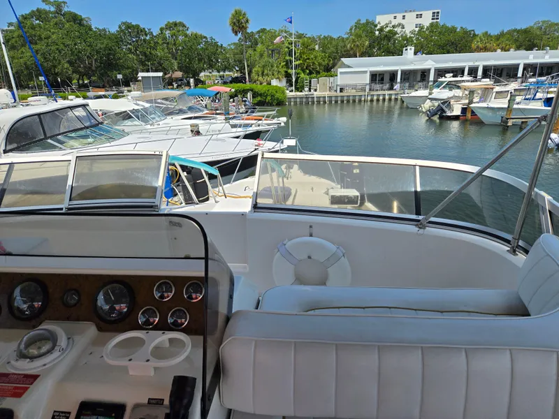 Slide: The Image of 1995 Sea Ray 440 Express Bridge yacht docked at a marina, view from the helm. - 8