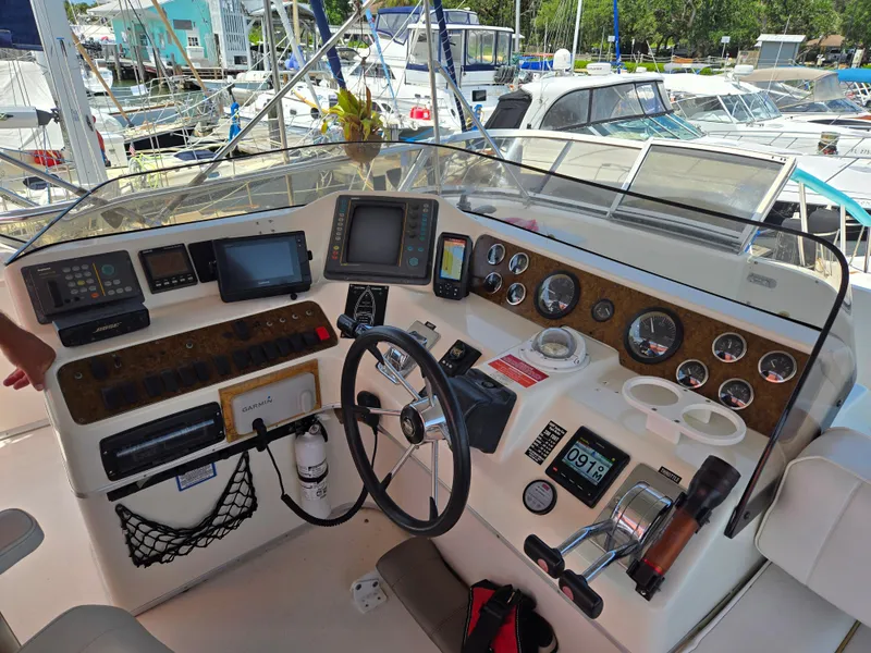 Slide: The Image of Cockpit of a 1995 Sea Ray 440 Express Bridge with navigation instruments and controls. - 9