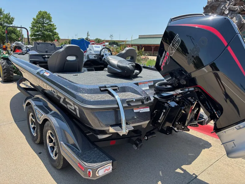 Slide: The Image of 2025 Nitro Z21 XL boat displayed outside Bass Pro Shops. - 2