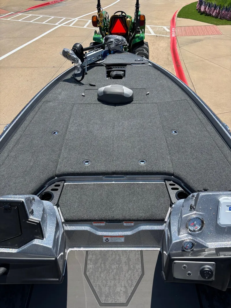 Slide: The Image of 2025 Nitro Z21 XL boat with spacious deck and dual seats in a parking area. - 4