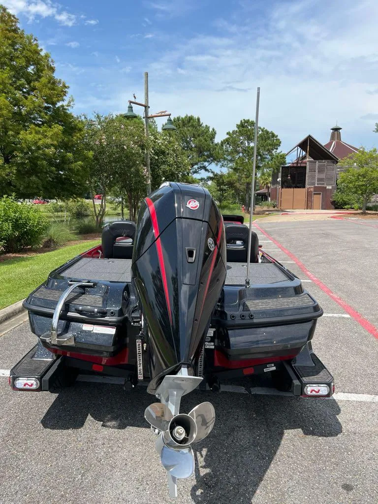 Slide: The Image of 2025 Nitro Z20 XL Pro boat with powerful outboard motor in a parking lot. - 2