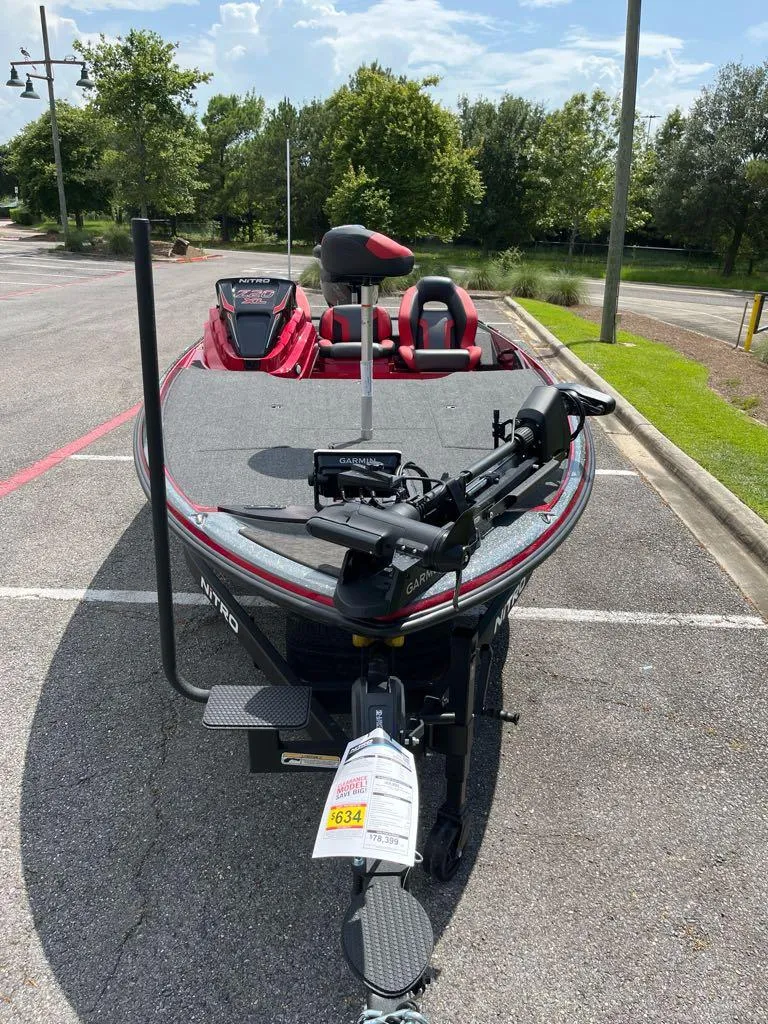 Slide: The Image of 2025 Nitro Z20 XL Pro boat in parking lot, featuring red and gray design. - 4