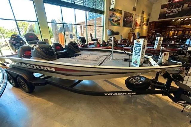 The Image of 2025 Tracker Savage 215 boat displayed in showroom with sleek design and modern features. - 0