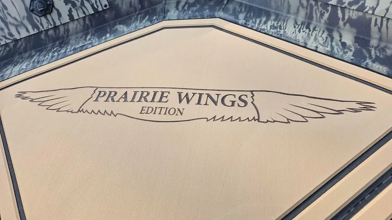 Slide: The Image of 2025 Tracker Grizzly 1650 T Prairie Wings Edition logo on boat floor. - 13