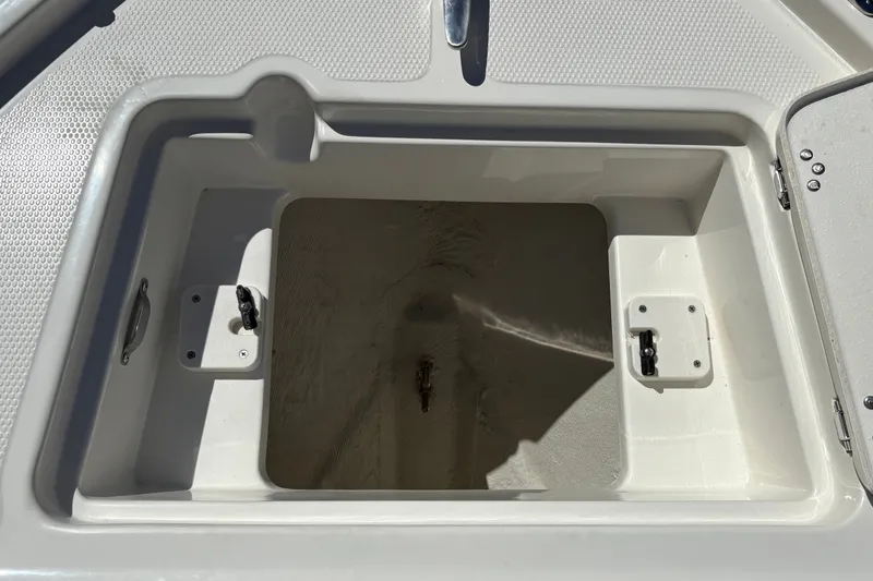 Slide: The Image of Open storage compartment on 2025 Mako 214 Center Console boat. - 29