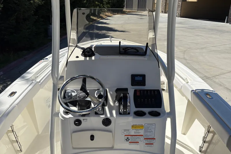 Slide: The Image of 2025 Mako 214 Center Console boat dashboard with steering wheel and controls. - 14