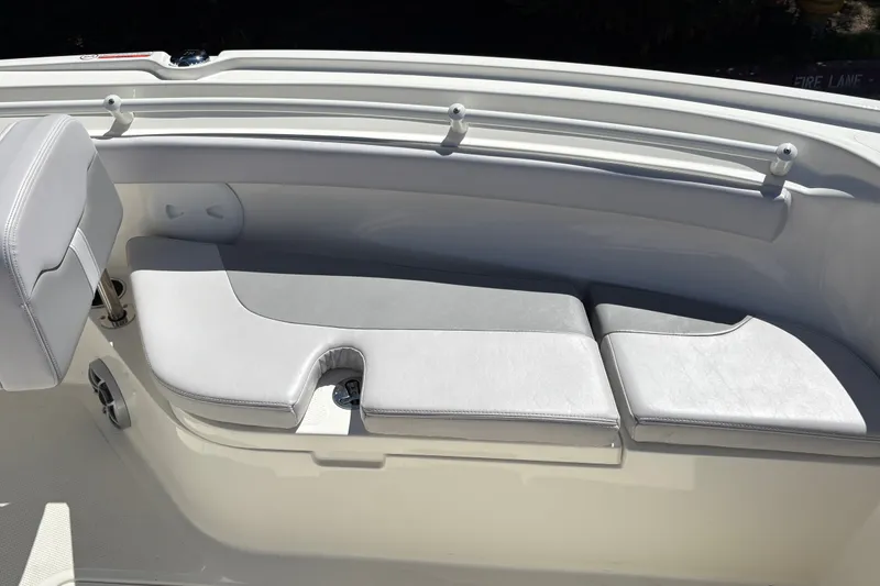 Slide: The Image of 2025 Mako 214 Center Console boat interior with cushioned seating. - 28