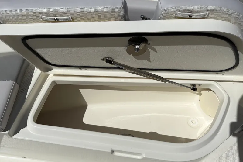 Slide: The Image of Open storage compartment on 2025 Mako 214 Center Console boat. - 30