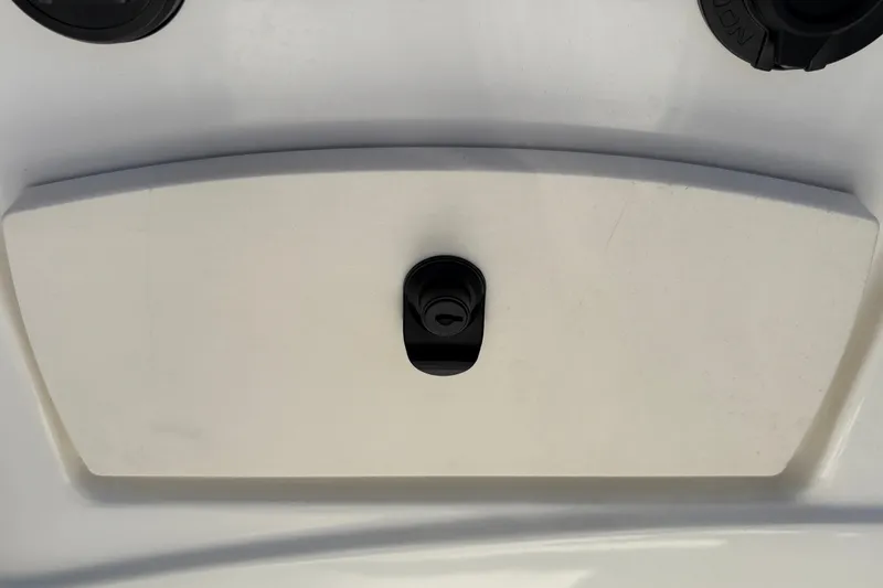 Slide: The Image of 2025 Mako 214 Center Console boat compartment with secure latch. - 20