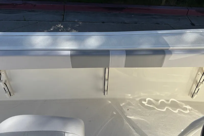 Slide: The Image of 2025 Mako 214 Center Console boat interior with white seating and sleek design. - 25