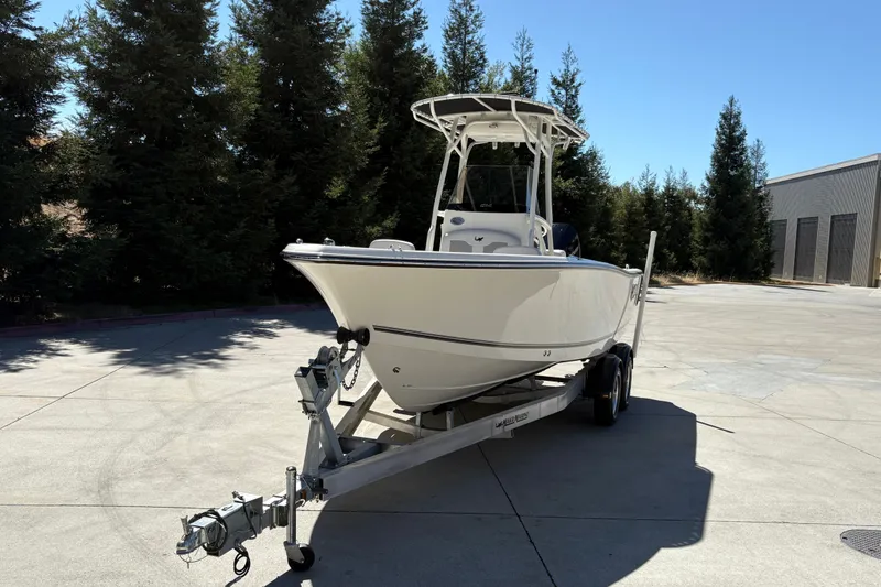 Slide: The Image of 2025 Mako 214 Center Console boat on trailer, parked outdoors. - 8