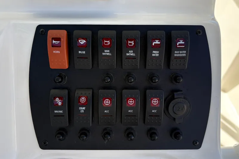 Slide: The Image of Control panel of 2025 Mako 214 Center Console boat with labeled switches. - 23