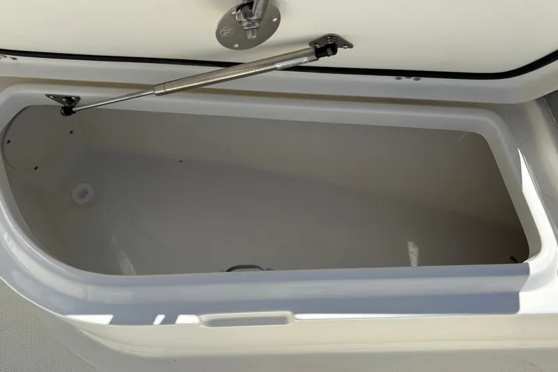 Slide: The Image of Open storage compartment on 2025 Mako 214 Center Console boat. - 22
