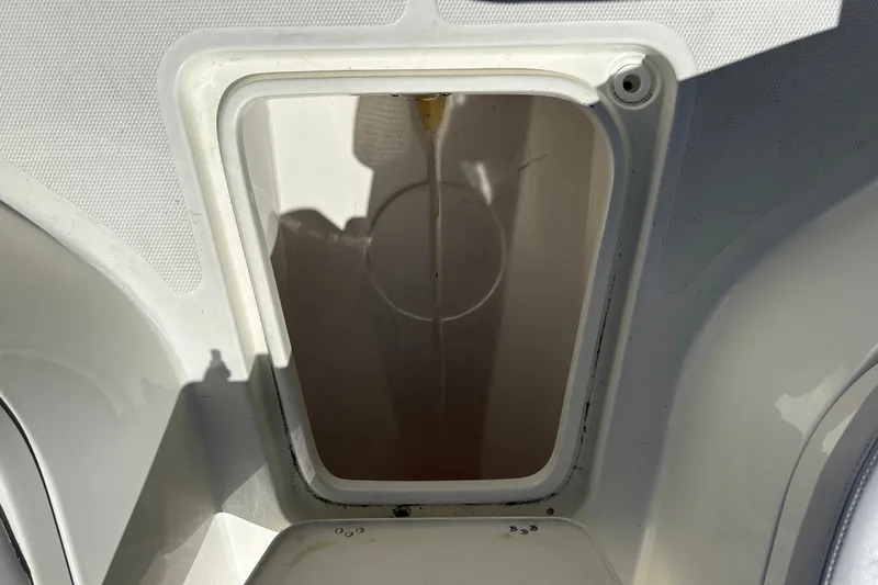 Slide: The Image of Open storage compartment on a 2025 Mako 214 Center Console boat. - 31