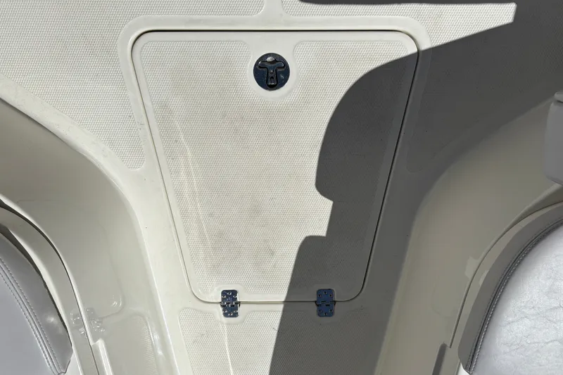 Slide: The Image of 2025 Mako 214 Center Console boat hatch with textured surface and secure latch. - 32