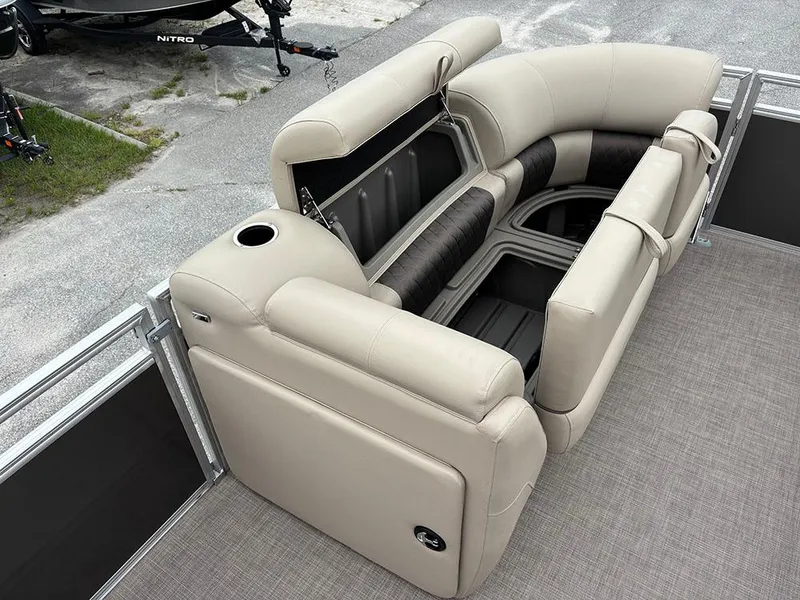 Slide: The Image of 2025 Sun Tracker Party Barge 20 DLX with luxurious seating and storage compartments. - 13