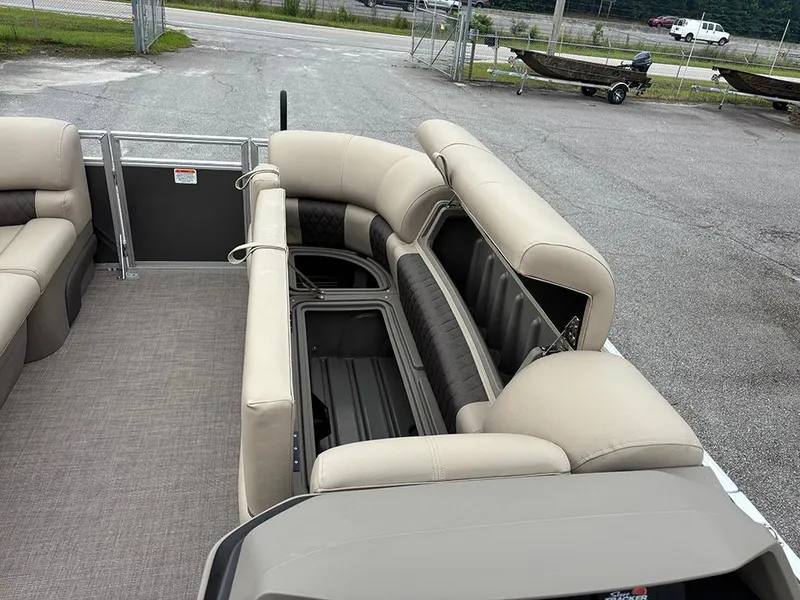 Slide: The Image of 2025 Sun Tracker Party Barge 20 DLX interior with beige seating and storage compartments. - 15