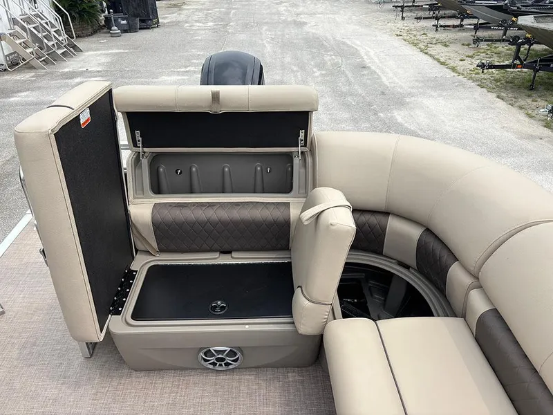 Slide: The Image of 2025 Sun Tracker Party Barge 20 DLX interior seating with storage compartments open. - 20
