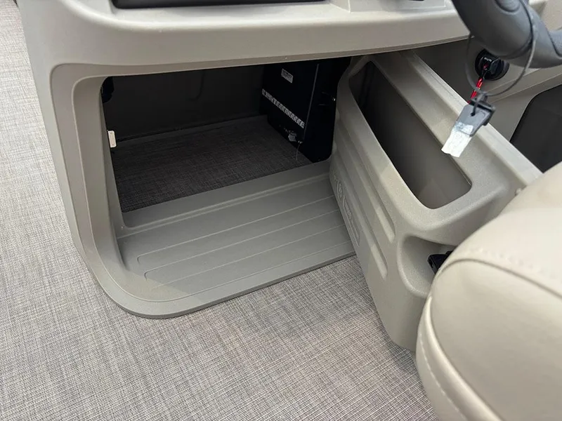 Slide: The Image of 2025 Sun Tracker Party Barge 20 DLX interior console with key and storage compartment. - 23