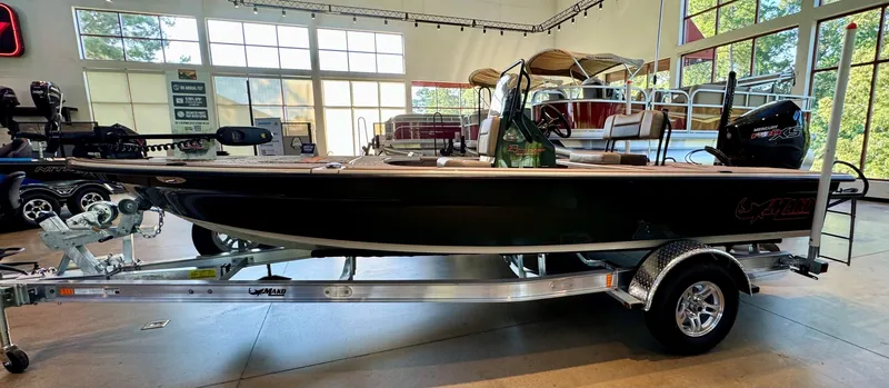 The Image of 2025 Mako 18 Pro Skiff Backwater Edition boat on trailer in showroom. - 0