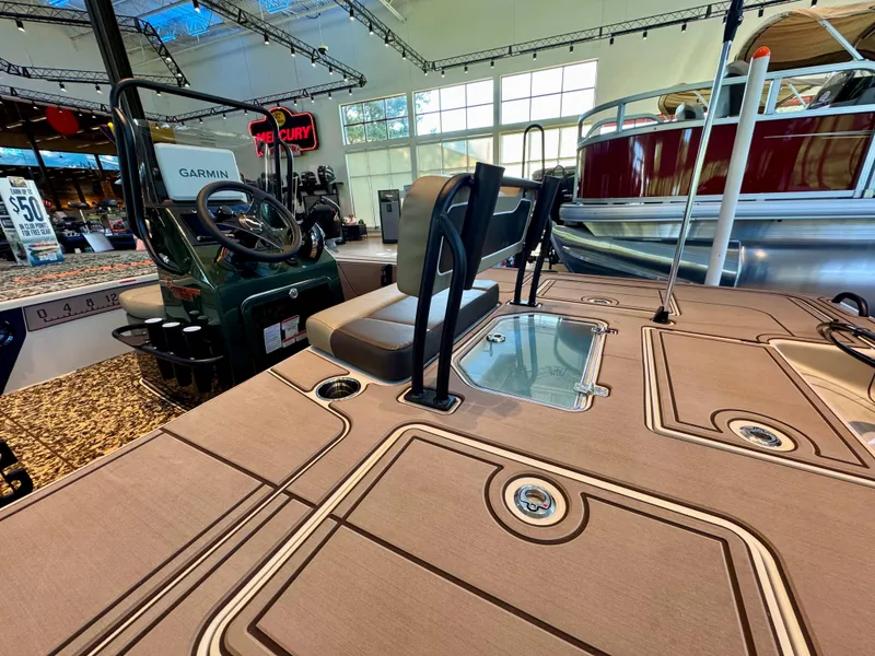 Slide: The Image of 2025 Mako 18 Pro Skiff Backwater Edition interior with Garmin system, showroom display. - 2