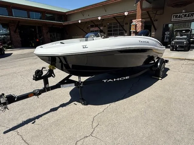 Slide: The Image of 2025 Tahoe T16 boat on trailer, parked outside a dealership. - 0