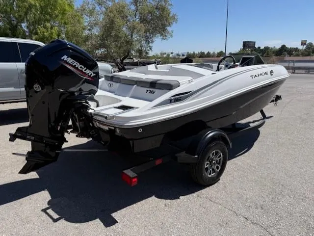 Slide: The Image of 2025 Tahoe T16 boat with Mercury engine on trailer, parked outdoors. - 1