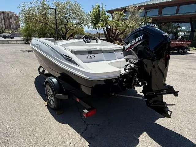 Slide: The Image of 2025 Tahoe T16 boat with Mercury engine on trailer, parked outdoors. - 2