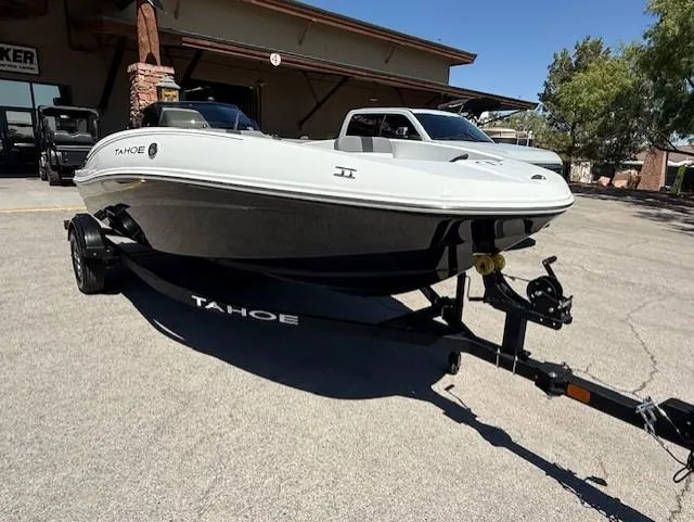 Slide: The Image of 2025 Tahoe T16 boat on trailer, parked outdoors near a building. - 3