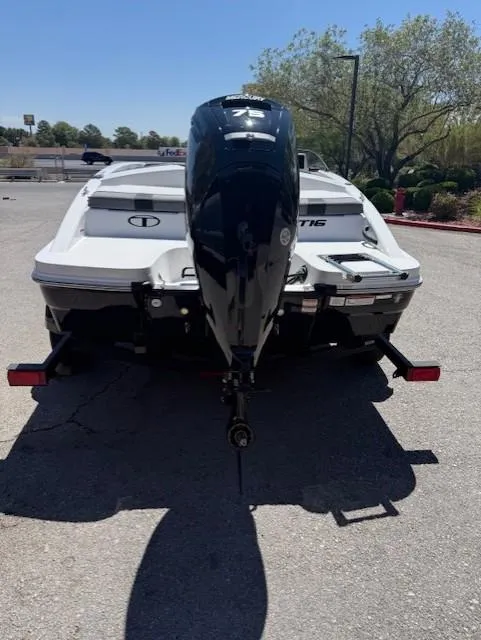 Slide: The Image of 2025 Tahoe T16 boat rear view with outboard motor in a parking lot. - 4