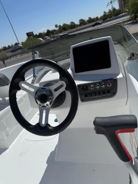 Slide: The Image of 2025 Tahoe T16 boat dashboard with steering wheel and control panel. - 5