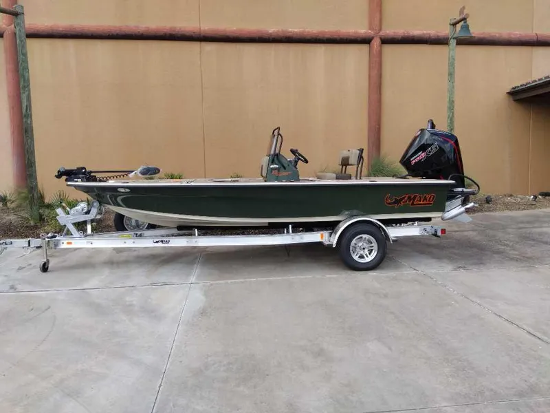 The Image of 2025 Mako 18 Pro Skiff Backwater Edition boat on trailer, parked outdoors. - 0