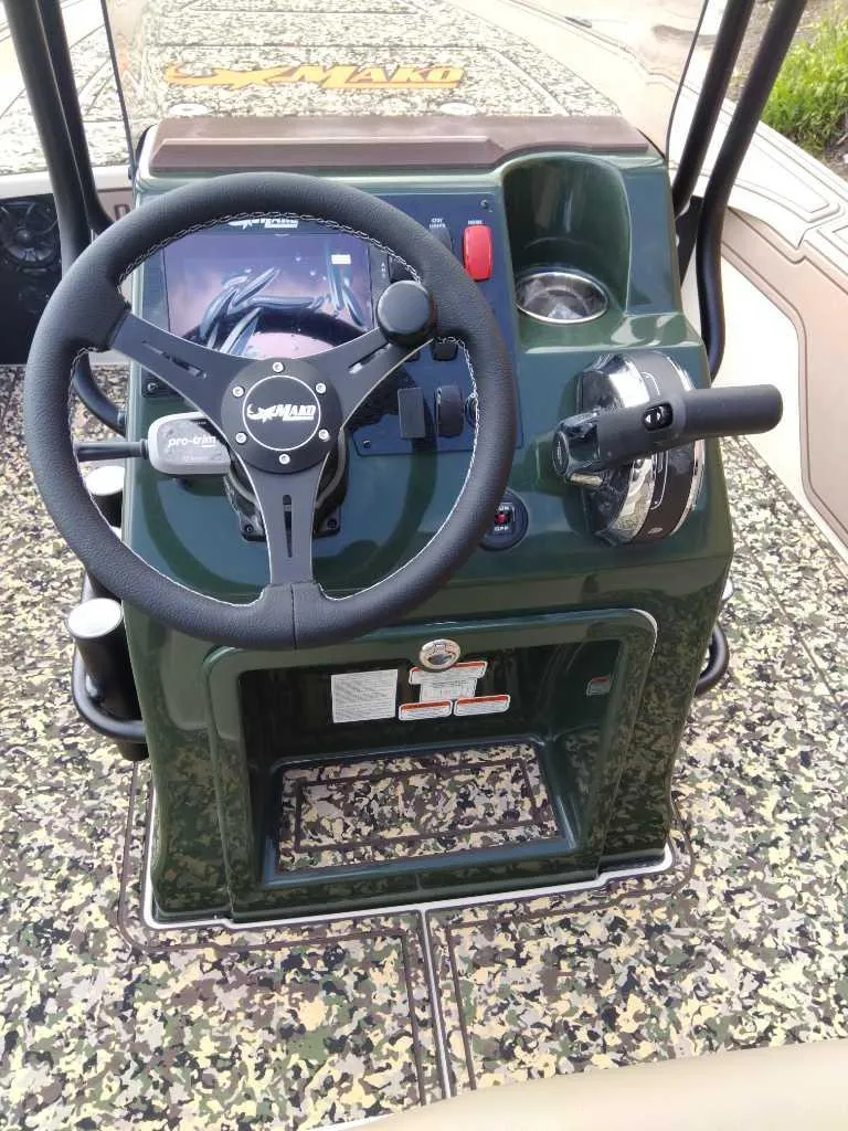 Slide: The Image of 2025 Mako 18 Pro Skiff Backwater Edition console with steering wheel and controls. - 3