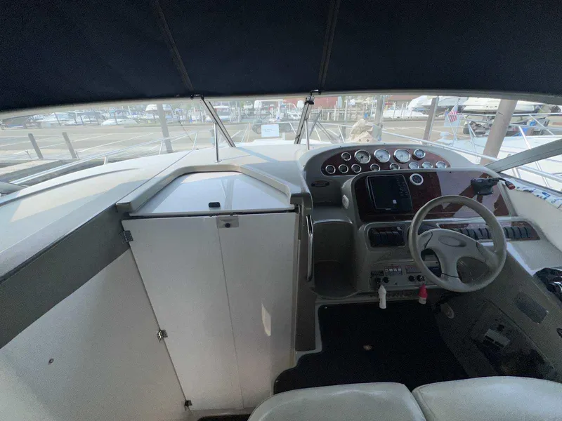 Slide: The Image of Cockpit of 2000 Bayliner 3055 Ciera Sunbridge DX/LX with steering wheel and control panel. - 13