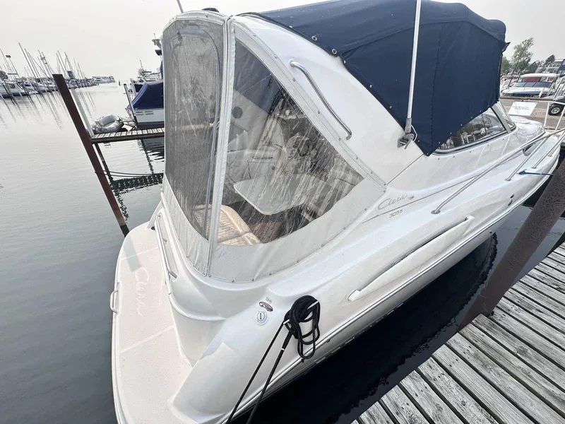 Slide: The Image of 2000 Bayliner 3055 Ciera Sunbridge DX/LX docked at marina with blue canopy. - 2