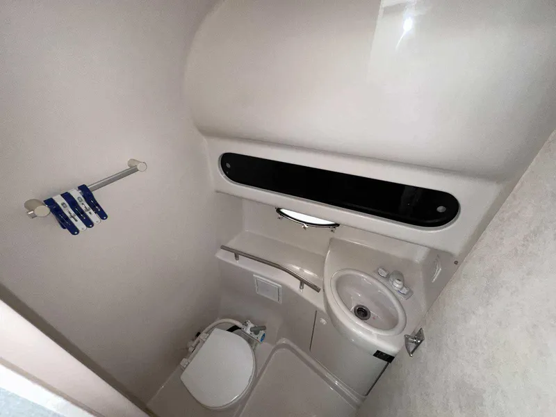 Slide: The Image of 2000 Bayliner 3055 Ciera Sunbridge DX/LX boat bathroom with toilet and sink. - 20