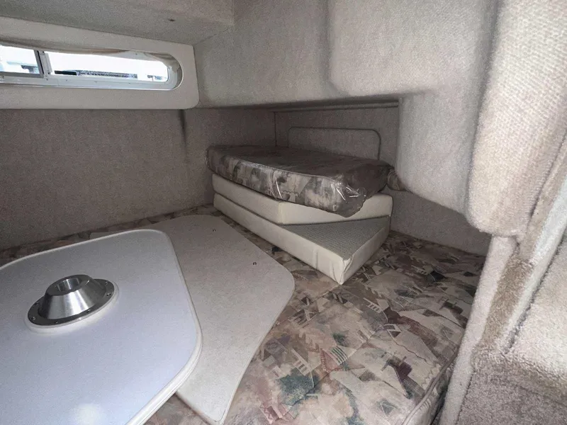 Slide: The Image of 2000 Bayliner 3055 Ciera Sunbridge cabin interior with cushions and table. - 26