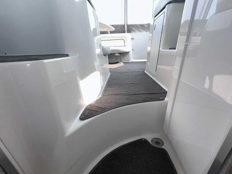 Slide: The Image of 2000 Bayliner 3055 Ciera Sunbridge DX/LX interior walkway with sleek white finish. - 28