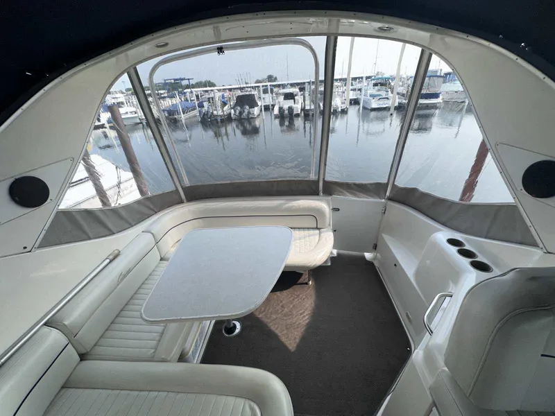 Slide: The Image of Interior view of 2000 Bayliner 3055 Ciera Sunbridge DX/LX with marina backdrop. - 3