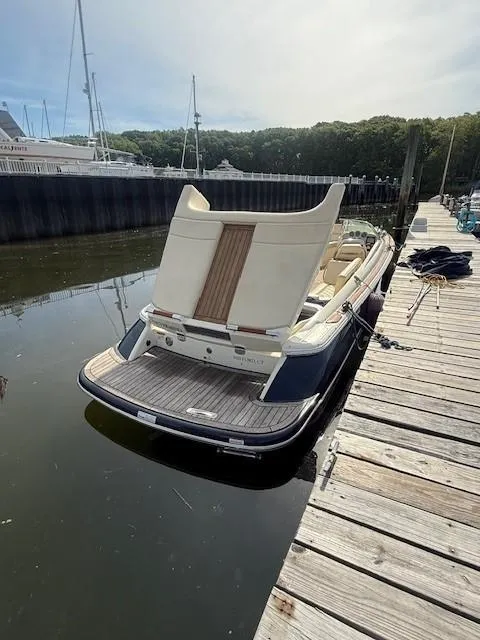 Slide: The Image of 2014 Chris-Craft Launch 25 boat docked in a marina, featuring elegant design and classic styling. - 29