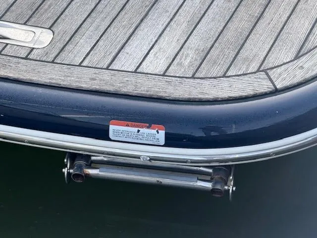 Slide: The Image of 2014 Chris-Craft Launch 25 boat stern with wooden deck and warning label. - 30
