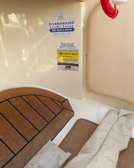 Slide: The Image of 2014 Chris-Craft Launch 25 interior with Harborside Yacht Sales sticker and capacity details. - 33