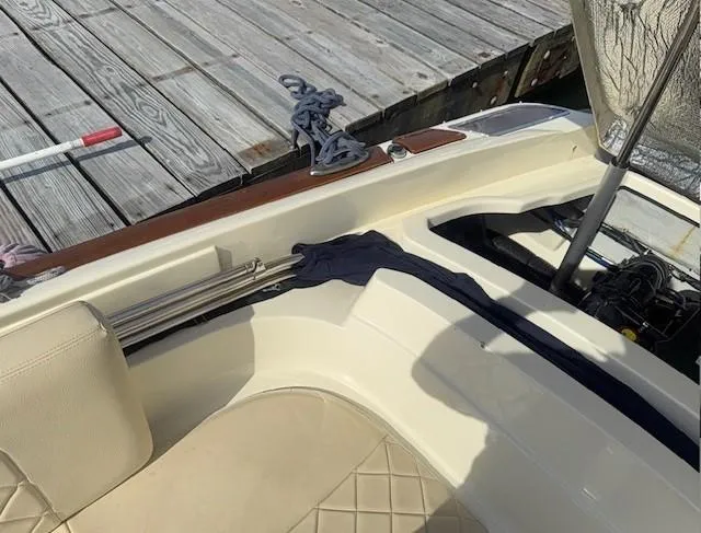Slide: The Image of 2014 Chris-Craft Launch 25 boat interior with beige seating and dockside view. - 34