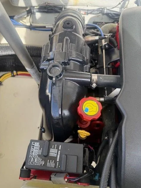 Slide: The Image of Engine compartment of a 2014 Chris-Craft Launch 25 boat, showcasing mechanical components. - 40