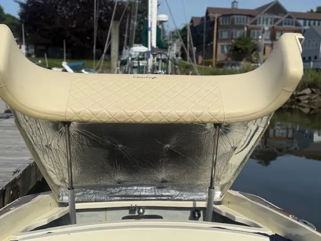 Slide: The Image of 2014 Chris-Craft Launch 25 boat with beige upholstery, docked near waterfront homes. - 45
