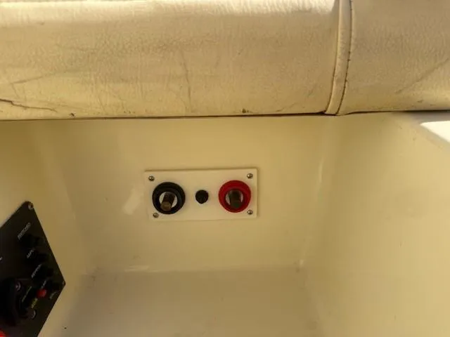 Slide: The Image of 2014 Chris-Craft Launch 25 boat interior with control panel and switches. - 48